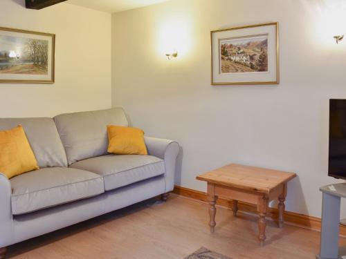 a living room with a couch and a coffee table at Harriet's Hideaway in Braithwaite