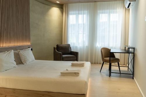 a bedroom with a bed and a desk and a chair at ORM - Santa Teresa Apartments in Porto