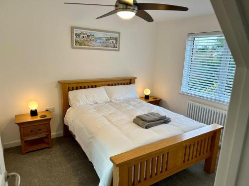 a bedroom with a large bed with two night stands at 4 Bedroom House, En-Suite, 3 Doubles 1 Single, 2 Car Parking in Colchester