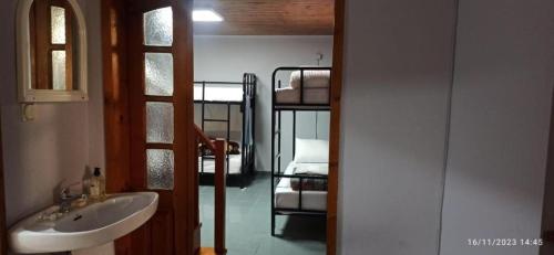 a bathroom with a sink and a bunk bed at ROYAL Hostel in Tirana