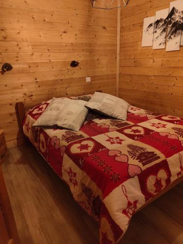 a bedroom with a bed in a wooden room at la ratavelaiza in Champagny-en-Vanoise