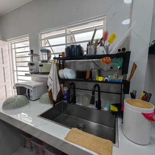 a kitchen with a sink and a counter top at VnV DORM HOMESTAY in Shah Alam