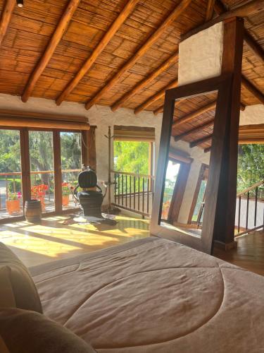 una camera da letto con un letto grande in una stanza con finestre di Hacienda La Armenia, Hotel Campestre BnB en Sopó a Sopo