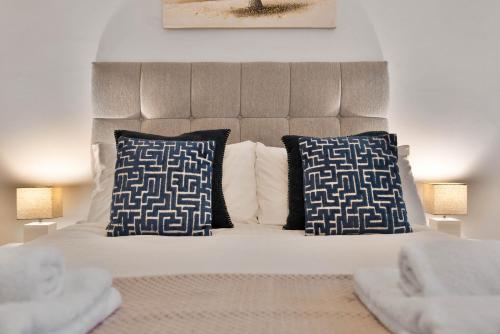 a bed with blue and white pillows in a bedroom at WhiskAwayHomes - St Stephens Court - Apartment 2 in Henwick