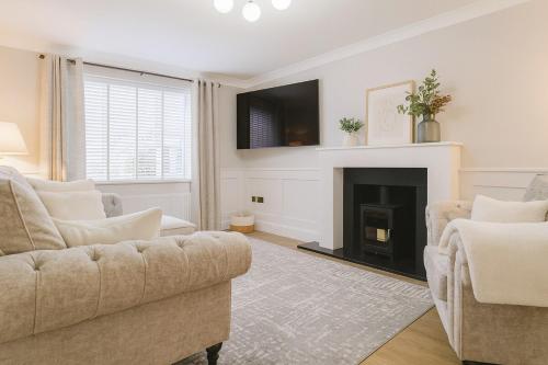 a living room with a couch and a fireplace at Bright and Spacious Blackwood Home 4 Bedroom Sleeps 8 in Blackwood