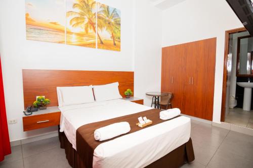 a bedroom with a large bed with towels on it at HOTEL SAN JUAN, Tarapoto in Tarapoto