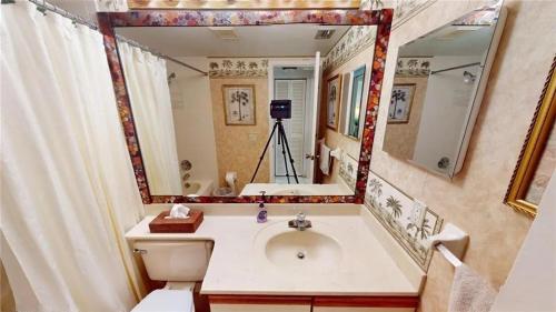 un bagno con un lavandino e un grande specchio di Relaxed Florida Living a Sebring Shores