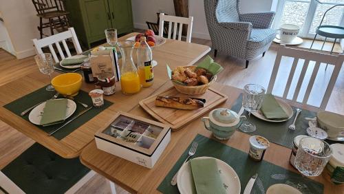 a dining room table with a plate of food and orange juice at Chambre Cheverny, Casa 103 in Messas