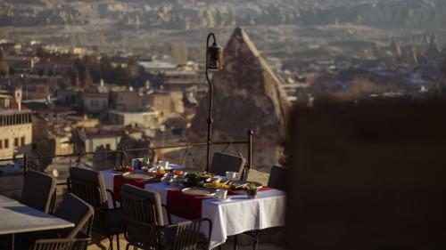 ギョレメにあるMithra Cave Cappadociaのバルコニーの上にテーブルと食器
