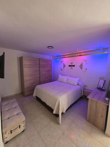 a bedroom with a large bed with purple lighting at Loft paradisse in Melilla