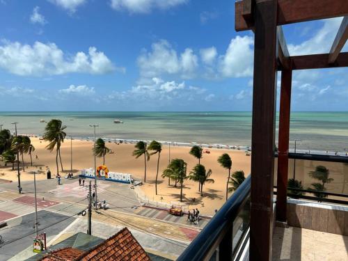 a view of a beach with palm trees and the ocean at Marinas Flat 420 in João Pessoa