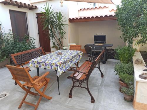 a patio with a table and chairs and a television at Casa Vacanze AnnaLù IUN R5074 in Orosei