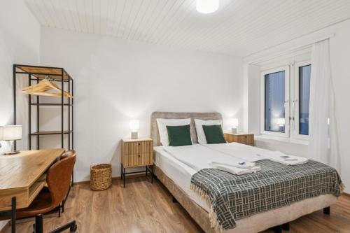 a bedroom with a bed and a table and a desk at Luxury 1BR in the city center - Color 5 in Zürich