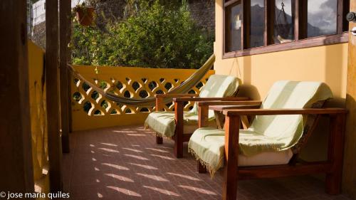 a group of chairs sitting on a balcony at Casa Cavoquinho in Paul