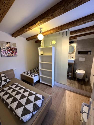 a room with a bathroom with a bed and a sink at Stone house Anja in Vrbnik