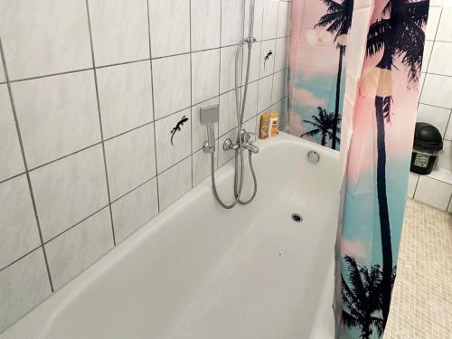 a bathroom with a bath tub with birds on the shower curtain at Fully equipped Apartment in Castrop-Rauxel in Castrop-Rauxel