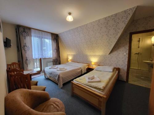 Ένα ή περισσότερα κρεβάτια σε δωμάτιο στο Willa u Tomali