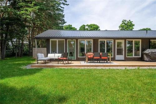 a house with a deck with a table and chairs at The County Haus - Indoor Pool & Finnish Sauna in West Lake