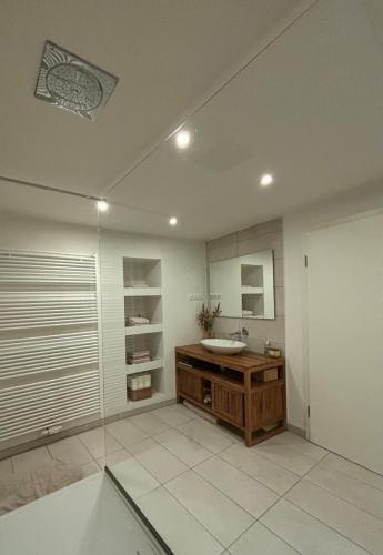 a bathroom with a sink and a mirror at Spacious house next Kirchberg-Centre with parking in Luxembourg