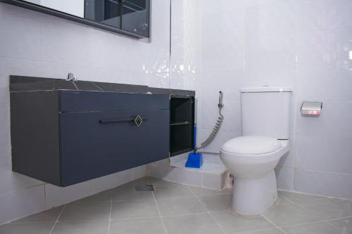 a bathroom with a toilet and a sink at Alya Hotel & Suites Ltd in Nairobi