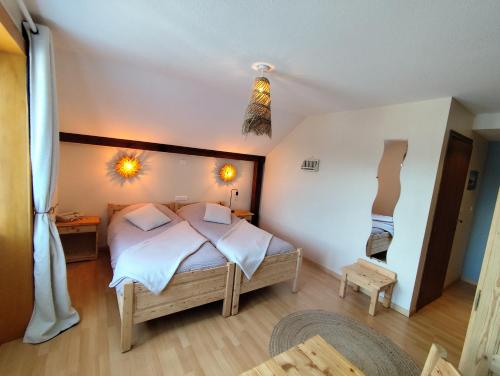 a bedroom with a bed in a room at LA MAISON Crêperie-Bar-Hôtel in Le Valtin