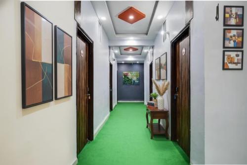 a corridor with a green floor in a building at FabHotel Super Corridor 