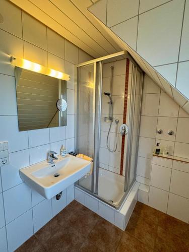 a bathroom with a sink and a shower at Hotel-Restaurant Gasthof Adler in Neuenburg am Rhein