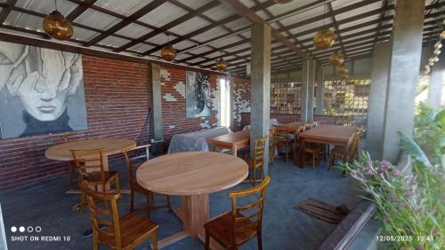 a restaurant with tables and chairs and a brick wall at Blue Sky Villa 02 Ahangama in Ahangama