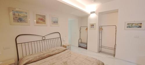 a bedroom with a bed and two mirrors on the wall at La Scalinata Suite in Perugia
