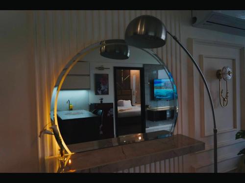 a mirror hanging on a wall with a bedroom at Montressa Executive Stay - Gold Crest Mall Phase 4 Lahore in Lahore