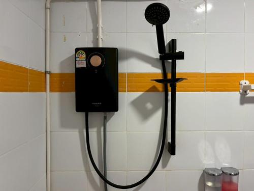 a shower with a hair dryer on a wall at Sabai House in Phi Phi Don