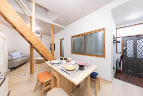 a kitchen and living room with a table and chairs at YUKIMARU in 2 in Tokyo