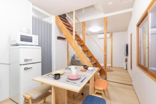 a small kitchen with a table and a staircase at YUKIMARU in 2 in Tokyo