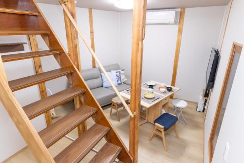 a living room with a ladder and a table at YUKIMARU in 2 in Tokyo