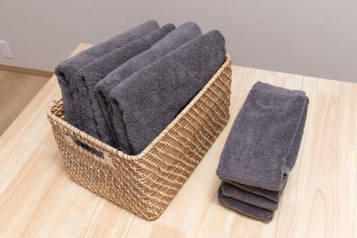 a basket of towels sitting on a wooden floor at YUKIMARU in 2 in Tokyo