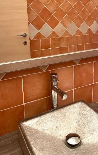 a sink with a faucet in a bathroom at Villa La Dolce Vista & Private hydro pool in Costa Paradiso