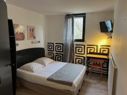 Ένα ή περισσότερα κρεβάτια σε δωμάτιο στο Hôtel Amarante