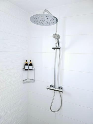 a shower with a shower head in a bathroom at Villa Mika in Alora