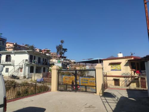a gate in a city with houses and buildings at Polet Mountain Resort in Mussoorie