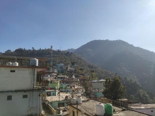 a view of a town with a mountain in the background at Polet Mountain Resort in Mussoorie