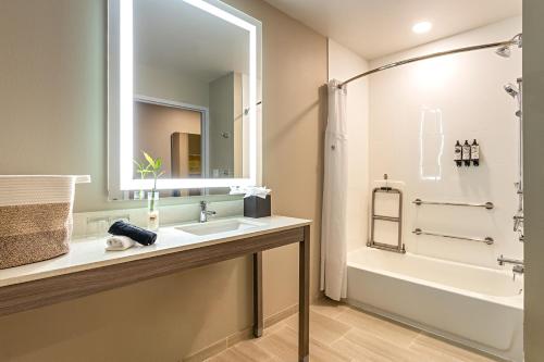 a bathroom with a sink and a shower and a tub at Pestana Orlando Suites - Lake Buena Vista in Orlando