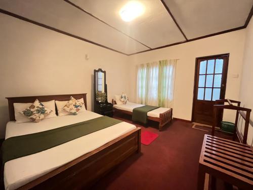Ένα ή περισσότερα κρεβάτια σε δωμάτιο στο The Green Savanna Holiday Bungalow Nuwara Eliya