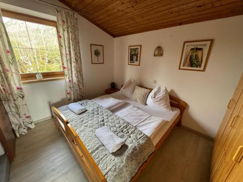 a bedroom with a bed with towels on it at Haus Imbachhorn Summer Card included in Zell am See