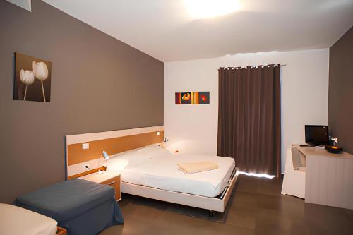 Ένα ή περισσότερα κρεβάτια σε δωμάτιο στο Ragusa Inn