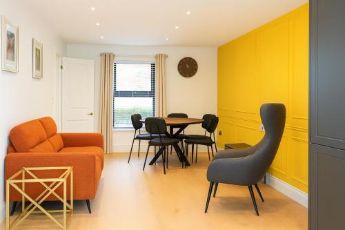 a living room with a table and chairs at 2 Bedroom House Cork City Centre in Cork