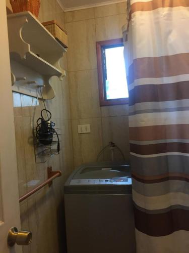 a small kitchen with a sink and a window at Cabaña Las Cruces in Las Cruces
