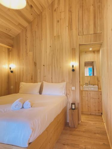 a bedroom with a bed with two towels on it at Domaine St-Amand in Saint-Amand-de-Coly