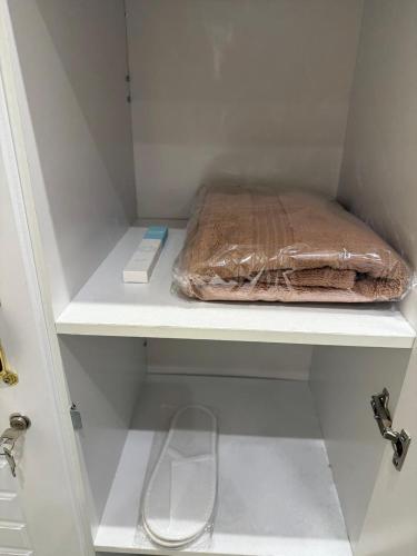 a brown bag sitting on a shelf in a closet at PrimeLuxe Stay by Lavishhub in Abu Dhabi