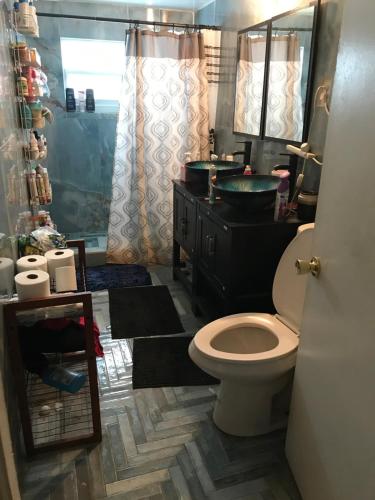 a bathroom with a toilet and a sink at PalmBeachDowntownPrivatHouseShare99perpersonupto5Party in West Palm Beach