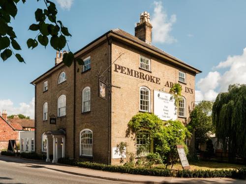 an old brick building on the side of a street at The Pembroke Arms in Wilton